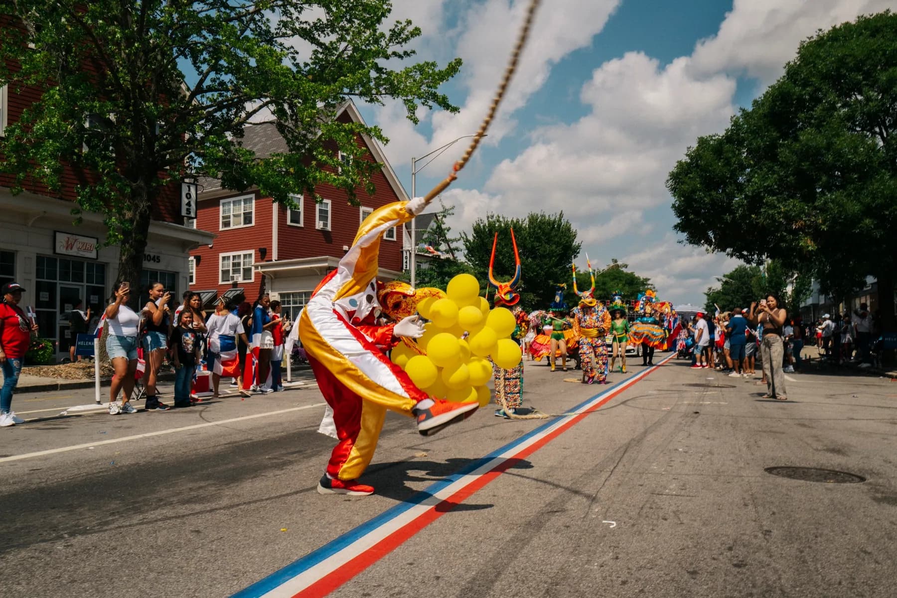 An ACM participant carries a handcrafted Carnaval mask during parade preparations