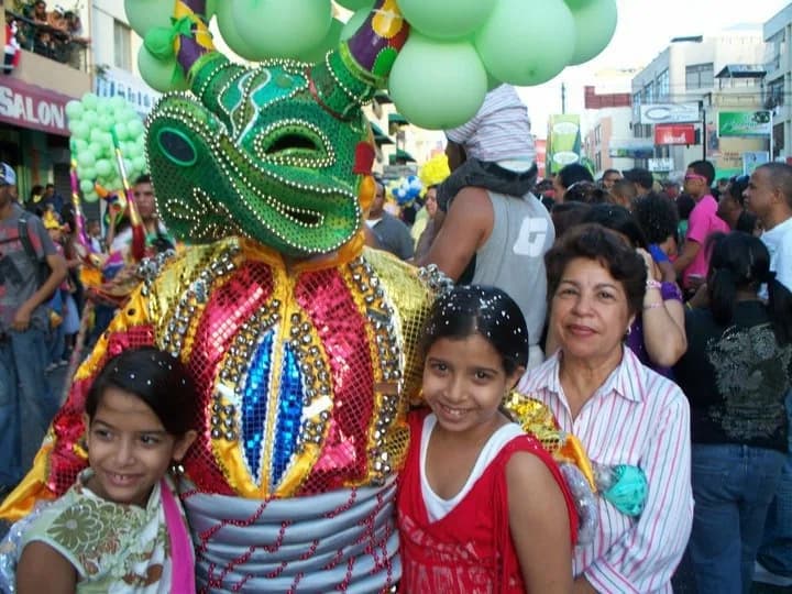 Children and adults sharing the Mirabal family Carnaval tradition at a neighborhood event