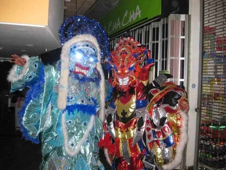 Historic ACM costumes and masks displayed together during an earlier celebration